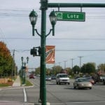 Street view of Lotz Street with traffic and street lamps.