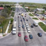 A busy highway with multiple lanes of cars and trucks in daylight.