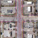 Aerial view of an urban intersection with marked utility lines.