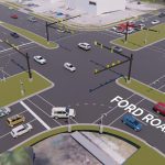 A busy intersection with multiple cars and traffic signals.